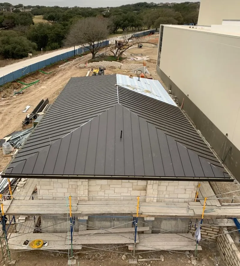 Metal roof new construction with scaffolding in Andover